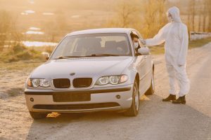 Person in a protective suit checks the temperature